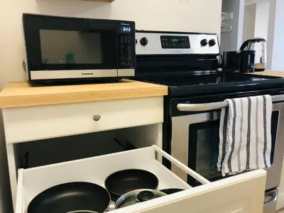 a microwave oven sitting on top of a kitchen counter at Cozy 1 Bedroom Condo with Parking in Calgary