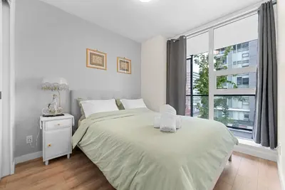a white bedroom with a large bed and a window at Brand new Stylists Richmond central 2B2BR in Richmond