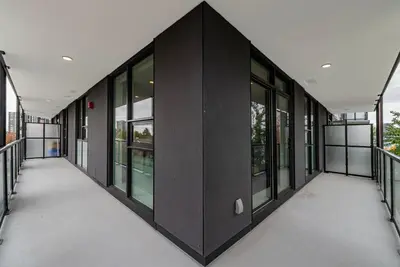 an empty hallway of a building with windows at Brand new Stylists Richmond central 2B2BR in Richmond