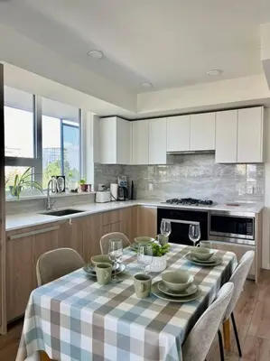a kitchen with a table with a checkered table cloth at Brand new Stylists Richmond central 2B2BR in Richmond