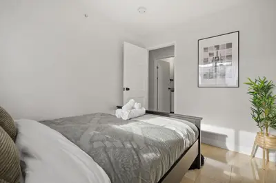 a bedroom with a bed with a stuffed animal on it at Spacious 4-Bedroom Retreat Near Bow River with Foosball, Dart Board, Movie Room in Calgary