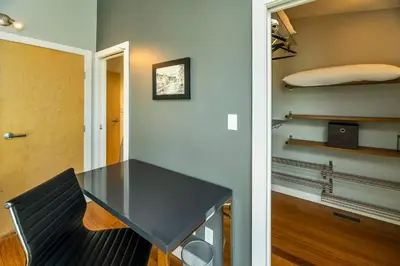 a dining room with a black table and a chair at NN - The Kit 4 - Downtown 1-Bed 1-Bath in Whitehorse