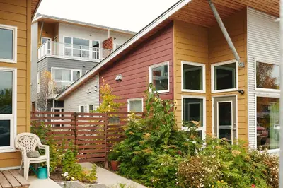 a house with a fence and a chair in a yard at NN - The Kit 4 - Downtown 1-Bed 1-Bath in Whitehorse