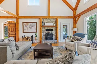a living room with a couch and a fireplace at Rolling Hills Retreat - Family Friendly in Millarville