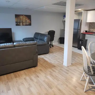 a living room with a couch and a table and chairs at Fabulous Room in Edmonton