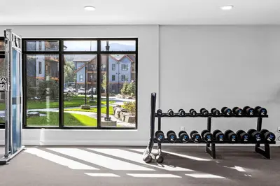a room with a bench in front of a window at Outdoor heated pool and hot tub Stunning 3Bd sanctuary in Dead Man's Flats