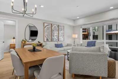 a dining room and living room with a table and chairs at Pool and hot tub Stunning 2Bd haven in the Rockies in Dead Man's Flats