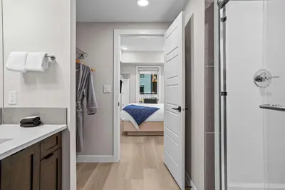 a bathroom with a walk in shower next to a bedroom at Pool and hot tub Stunning 2Bd haven in the Rockies in Dead Man's Flats
