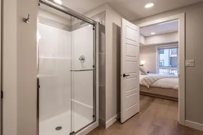 a bathroom with a shower with a glass door at La Sombra at Sparrowhawk Lodge Brand New 2Bd in Dead Man's Flats