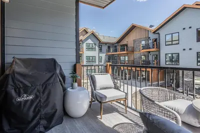 a balcony with two chairs and a table at La Sombra at Sparrowhawk Lodge Brand New 2Bd in Dead Man's Flats