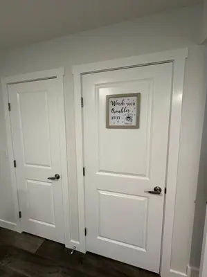 a pair of white doors with a sign on them at The Urban Nest in Calgary