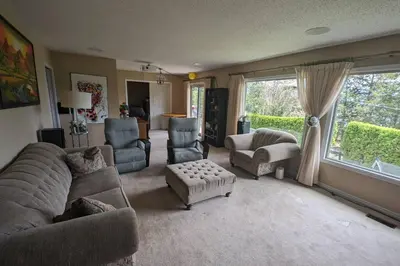 a living room with a couch and chairs and a window at Spacious West Kelowna Home that is great for family, friends, or business trip! in West Kelowna