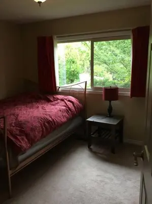 a bedroom with a bed and a window at Spacious West Kelowna Home that is great for family, friends, or business trip! in West Kelowna