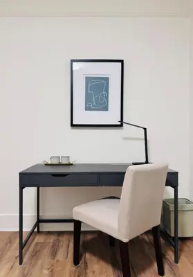 a black desk with a white chair and a picture at Deluxe Queen Room Private Ensuite Vancouver West in Vancouver