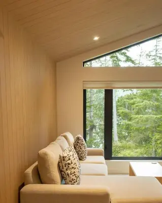 a living room with two couches and a large window at Calmwater Retreat New 2 br Hot Tub in Ucluelet