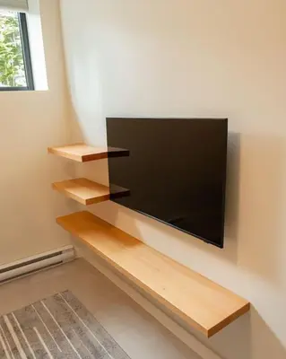 a flat screen tv hanging on a wall at Calmwater Retreat New 2 br Hot Tub in Ucluelet