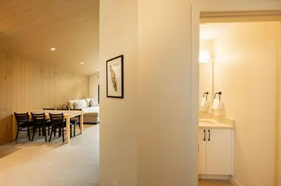 a kitchen and dining room with a table and chairs at Calmwater Retreat New 2 br Hot Tub in Ucluelet
