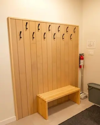 a locker room with a wooden wall with a bench at Calmwater Retreat New 2 br Hot Tub in Ucluelet