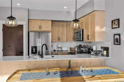 a kitchen with wooden cabinets and a counter top at Powder Heights #15 home in Sun Peaks