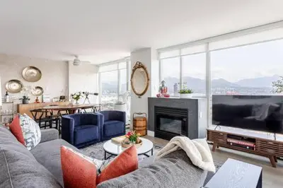 a living room with a couch and a large television at Luxury 2 Bed 2 Bath Condo Downtown Vancouver with Free Parking in Vancouver