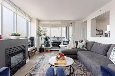 a living room with a couch and a fireplace at Luxury 2 Bed 2 Bath Condo Downtown Vancouver with Free Parking in Vancouver