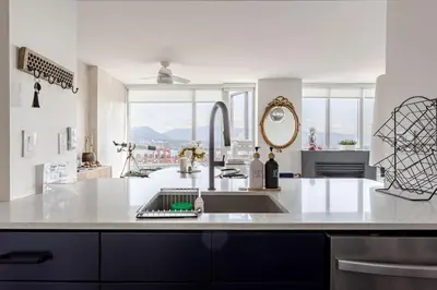 a kitchen with a sink and a large window at Luxury 2 Bed 2 Bath Condo Downtown Vancouver with Free Parking in Vancouver