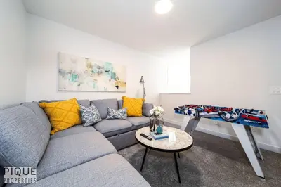a living room with a couch and a table at Modern Executive Home-Sleeps12-KingBeds-FullHouse in Edmonton