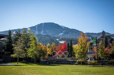 a park with two olympic rings in front of a mountain at 1BR in Gondola Village, Near Gondola, Free Parking, Updated Unit, Incredible Location in Whistler