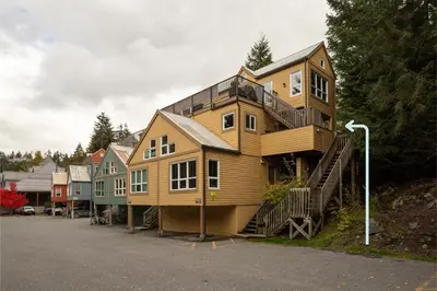 a large wooden house on the side of a street at 1BR in Gondola Village, Near Gondola, Free Parking, Updated Unit, Incredible Location in Whistler