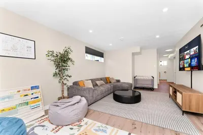 a living room with a couch and a table at BunkBedDreams,10 Beds,Near Rogers place and Nait in Edmonton