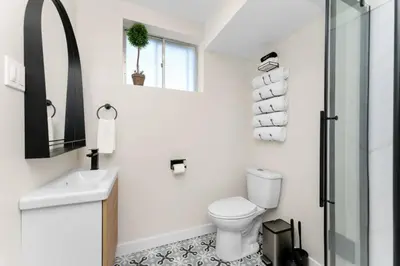 a bathroom with a toilet and a sink and a shower at BunkBedDreams,10 Beds,Near Rogers place and Nait in Edmonton