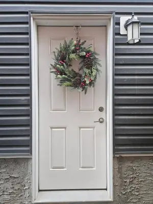 a white door with a christmas wreath on it at Wola's Place in Calgary