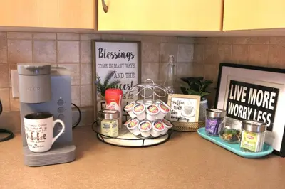 a kitchen counter with coffee cups and other items on it at The WEM House in Edmonton