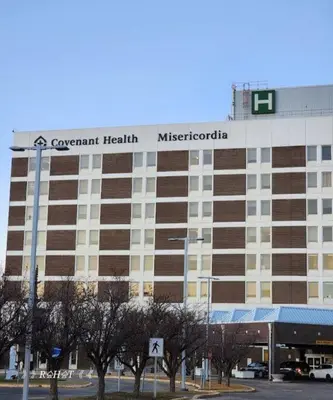 a large building with a sign on top of it at The WEM House in Edmonton