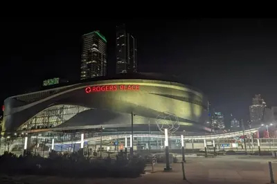 a building with a sign on it at night at The WEM House in Edmonton