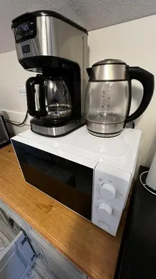 a microwave with a coffee pot on top of it at ALL NEW 2BR Loft in Chilliwack