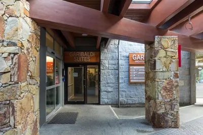 an entrance to a building with a stone wall at Tantalus Penthouse Mountain and Village Views in Whistler