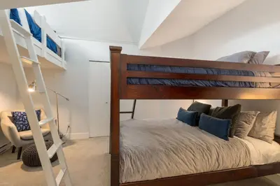 a bedroom with a bunk bed and a ladder at Black Tusk - Top Floor, Best Location, Mtn Views in Whistler