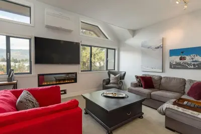 a living room with a couch and a tv at Black Tusk - Top Floor, Best Location, Mtn Views in Whistler