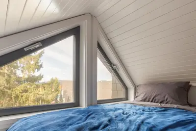 a bedroom with a bed and a large window at Black Tusk - Top Floor, Best Location, Mtn Views in Whistler