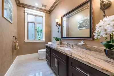 a bathroom with a sink and a toilet and a mirror at Jovehouse in Vancouver