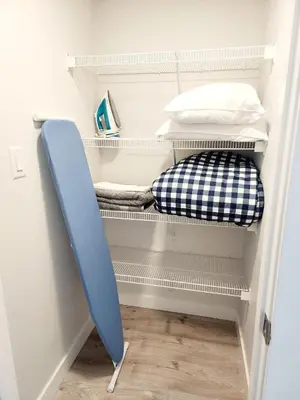 a room with a blue surfboard in a closet at Luxury Cozy Basement in Leduc