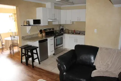 a living room with a couch and a kitchen at Selah Retreat Guesthouse B&B in Sorrento