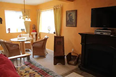 a living room with a fireplace and a tv at Selah Retreat Guesthouse B&B in Sorrento
