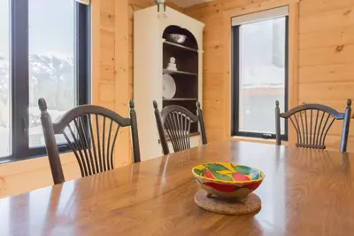a wooden table with a bowl on top of it at Snow Pines by StayIn in Fernie