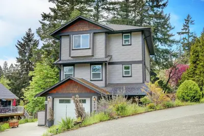 a gray house with a white garage at Modern Home in Victoria, BC in Victoria