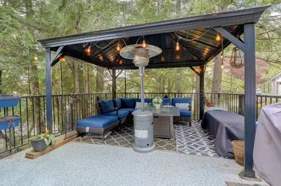 a gazebo with a table and chairs on a deck at Modern Home in Victoria, BC in Victoria