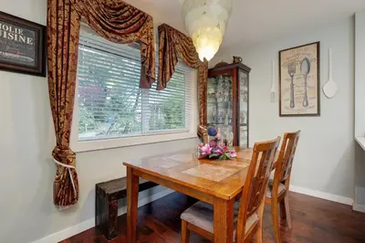 a dining room with a wooden table and chairs at Modern Home in Victoria, BC in Victoria