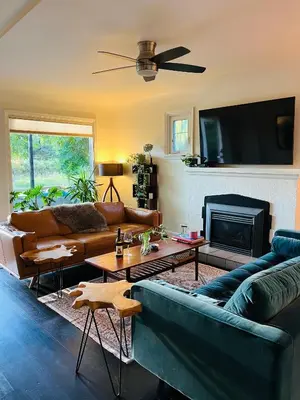 a living room with a couch and a fireplace at Hikari-Okanagan Sunshine B&B in Kelowna