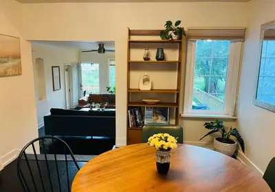 a living room with a wooden table with flowers on it at Hikari-Okanagan Sunshine B&B in Kelowna